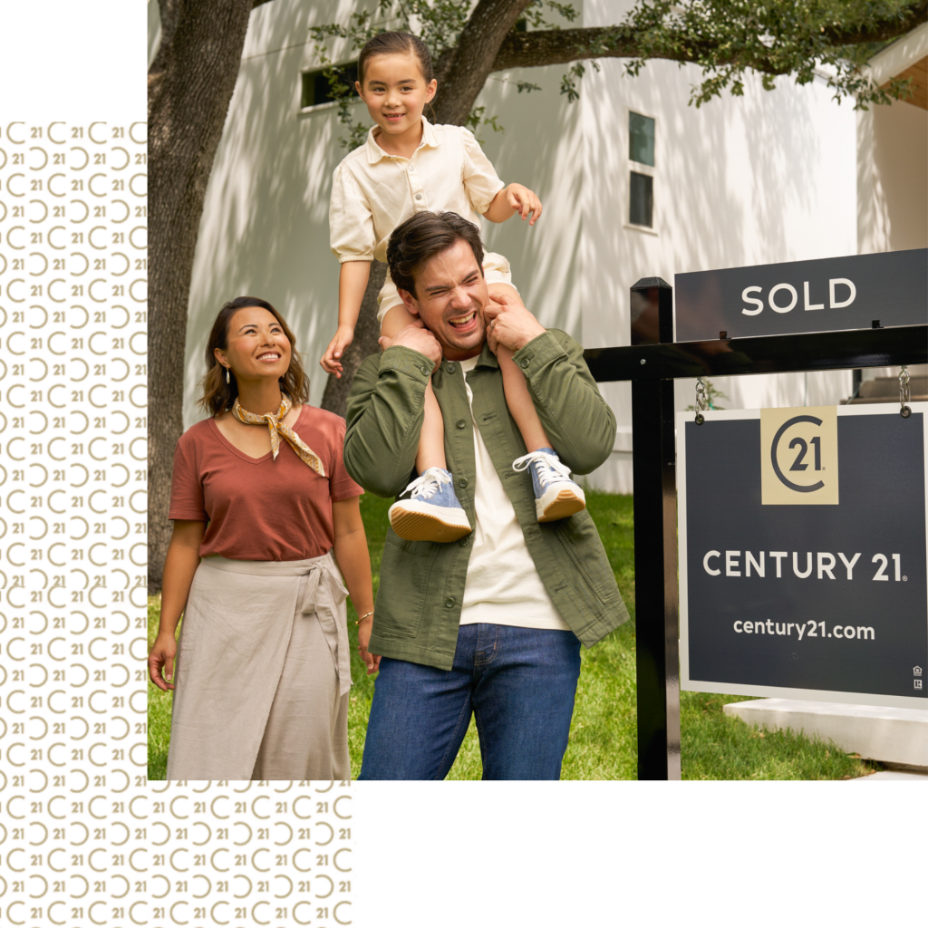 A happy family of three beside a home sold by Century 21.